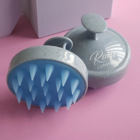 Roxie Cosmetics Stimulating Scalp Massager Brush - product displayed with its packaging on a dark background